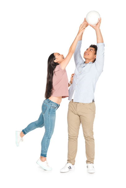 young asian man and woman playing volleyball on white background - Foto, immagini