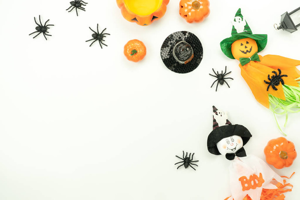 Table top view aerial image of decoration Happy Halloween day background concept.Flat lay accessories essential object to party the pumpkin & doll and hat on white wooden.Space for creative design. - Foto, afbeelding