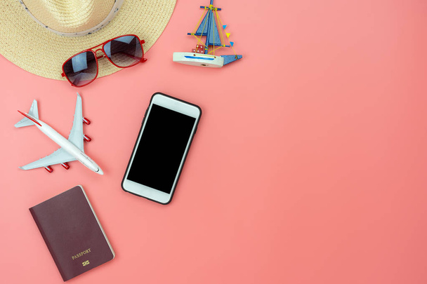 Flat lay image of accessory clothing man or women to plan travel in holiday background concept.Mobile phone & passport with many item in vacation season.Table top view several object on pink paper. - Photo, Image