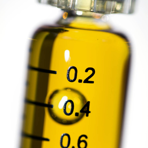 Syringe with CBD cannabis oil on white background - 写真・画像