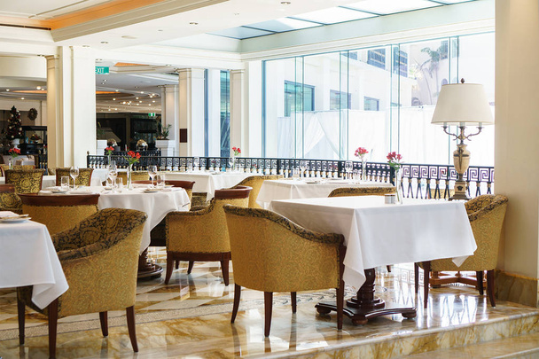 COSTA DE ORO, AUSTRALIA - DICIEMBRE DE 2018: Mesas de comedor preparadas para el almuerzo en Versace Hotel, el primer hotel de marca de moda del mundo, ubicado junto al Southport Broadwater en Main Beach
. - Foto, Imagen
