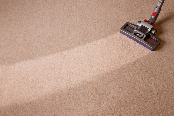 Housekeeper doing vacuum cleaning. Maid vacuuming the carpet. Ca - Valokuva, kuva
