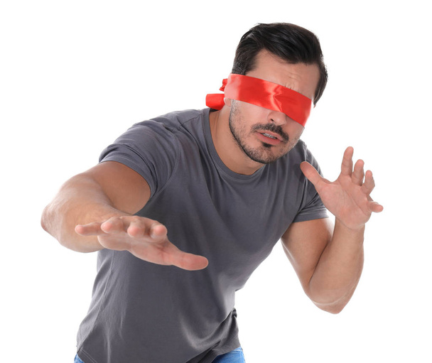 Young man wearing red blindfold on white background - Photo, Image