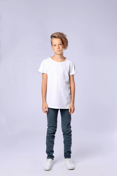 Cute little boy in casual outfit on light background - Foto, afbeelding