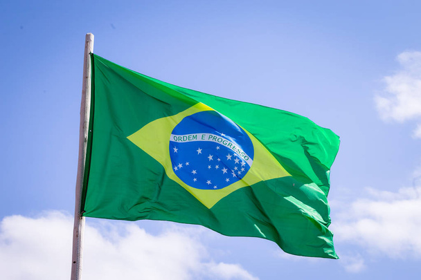 Brazylia flaga tkaniny tekstylne machając na górze, Błękitne niebo Brazylii, koncepcja patriotyzmu. - Zdjęcie, obraz