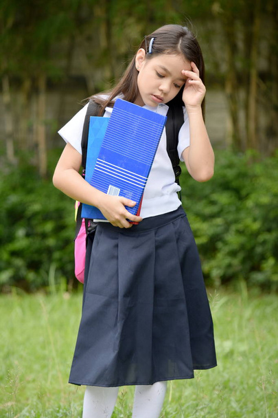 Depressed Female Student Wearing Uniform With Books - Valokuva, kuva