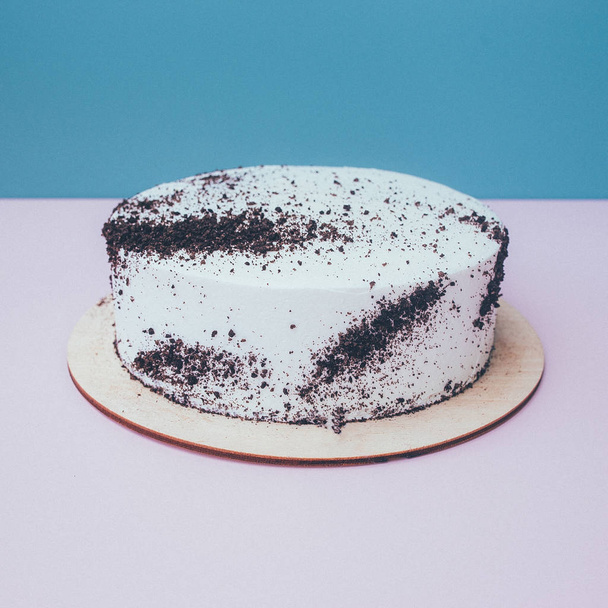 a cut of cake with whipped cream on the table background. - Photo, Image