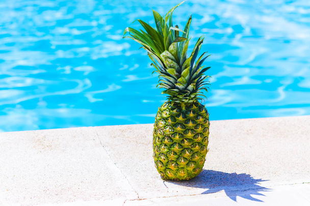 Healthy fruit, pineapple by the pool - Фото, изображение
