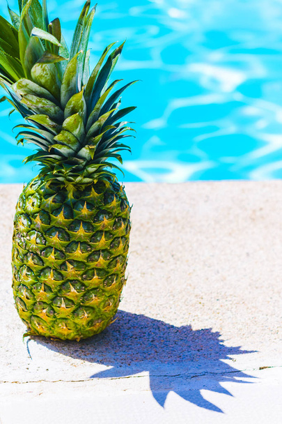 Healthy fruit, pineapple by the pool - Foto, immagini
