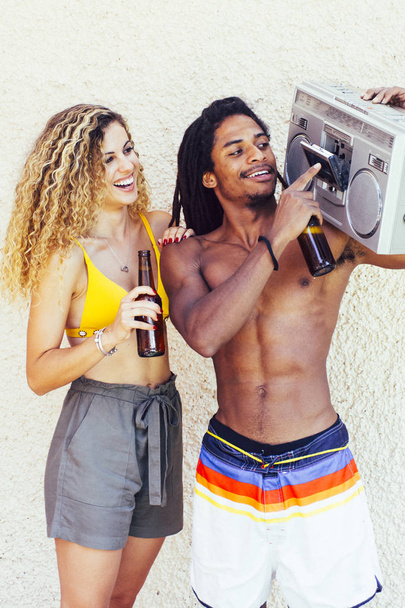 Interracial couple listen music and drinking - Fotó, kép