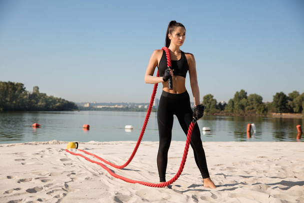 Young healthy female athlete doing workout at the beach - Foto, Imagem