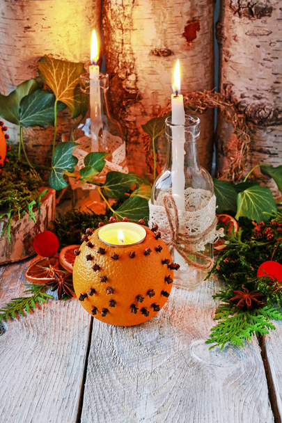 Christmas home decoration with pomander, candles, moss and parad - Fotoğraf, Görsel
