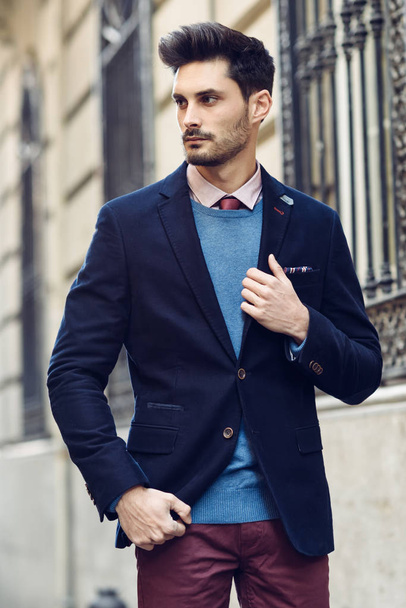 Attractive man wearing british elegant suit in the street. Modern hairstyle. - Foto, imagen