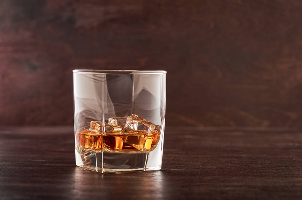 Glass of whiskey on a wooden table - Zdjęcie, obraz