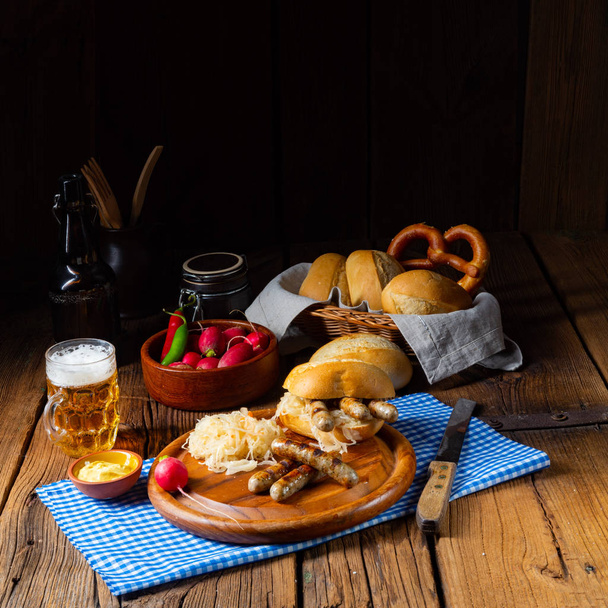 rustic Thuringian bratwurst with sauerkraut and roll - 写真・画像