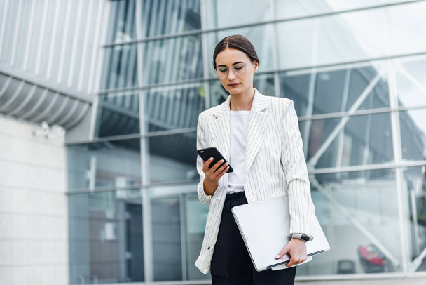 Successful businessman working at laptop. Business woman working. Sales woman working using her laptop while writing text. Businesswoman in glasses working on-line. Mobile technology. - 写真・画像