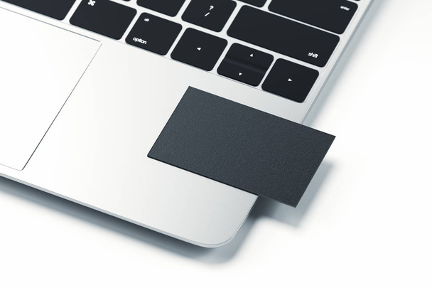 Close up of black realistic modern business card on laptop on light background. 3d rendering. - Fotoğraf, Görsel