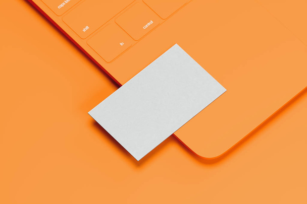 Orange laptop with white blank business card on orange background. 3d rendering. Cozy working place. Minimalism - Photo, image