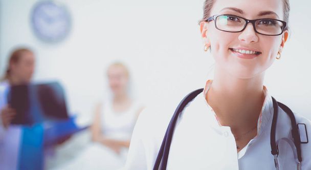 Young woman doctor standing at hospital with medical stethoscope - Fotó, kép
