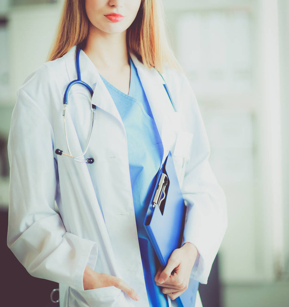Portrait of woman doctor with folder at hospital corridor - Фото, изображение