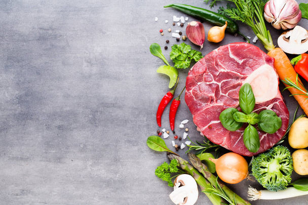 Raw fresh meat Ribeye Steak with vegetables and spice. - Fotoğraf, Görsel