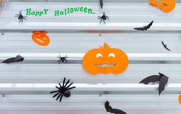 Halloween party concept. Pumpkins, bats, spiders on the decorated wall for halloween night party. - Photo, Image