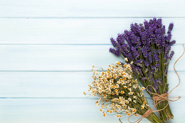 Grooming products and fresh lavender bouquet on white wooden tab - 写真・画像