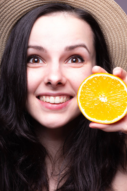 beautiful young girl with oranges, hat - 写真・画像