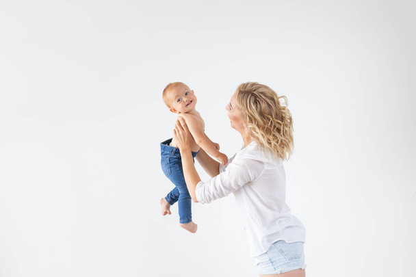 Happy mother with adorable baby on white background with copy space - Valokuva, kuva
