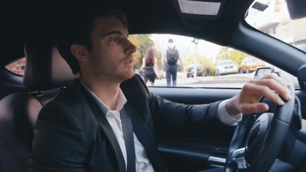 Handsome Businessman Driving a Car. Portrait of a Young Confident Man is Driving Car in a City. - Footage, Video