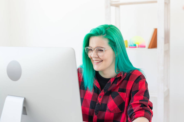 Σχεδιαστής, εικονογράφος, καλλιτέχνης και άνθρωποι concept-πορτρέτο της σύγχρονης νεαρής γυναίκας με πράσινα μαλλιά χρησιμοποιώντας φορητό υπολογιστή ενώ εργάζονται - Φωτογραφία, εικόνα