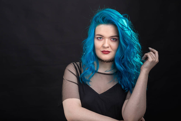People, style and fashion concept - Close up portrait of young woman with blue long hair dressed in black dress - Photo, Image