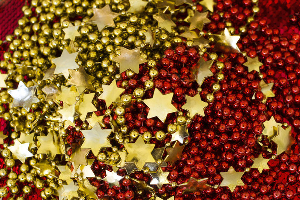Christmas and New Year background. Red and blue, golden garlands, balls. Golden beads Gold Jewelry. Golden beads. Christmas decorations - Zdjęcie, obraz