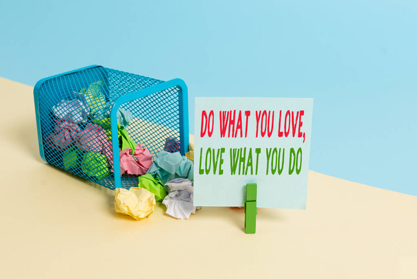 Text sign showing Do What You Love Love What You Do. Conceptual photo Pursue your dreams or passions in life Trash bin crumpled paper clothespin empty reminder office supplies tipped. - Photo, Image