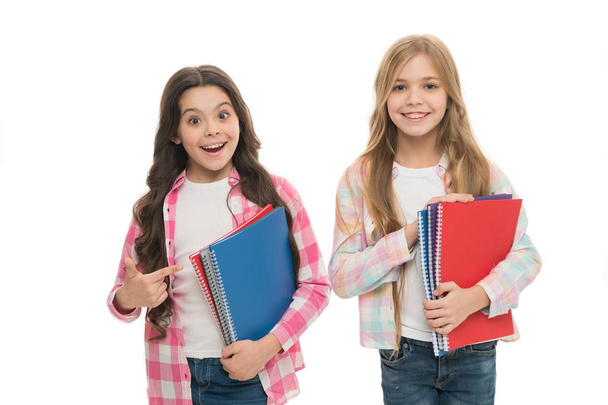Collection of exercise books is ready for the school term ahead. Cute small children holding note books. Adorable little girls with school exercise books. Preparing activity books for writing - Photo, Image