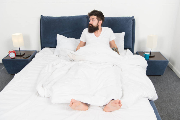 asleep and awake. Too early to wake up. bearded man hipster sleep in morning. mature male with beard in pajama on bed. brutal sleepy man in bedroom. energy and tiredness. Sleepy and handsome - Фото, изображение