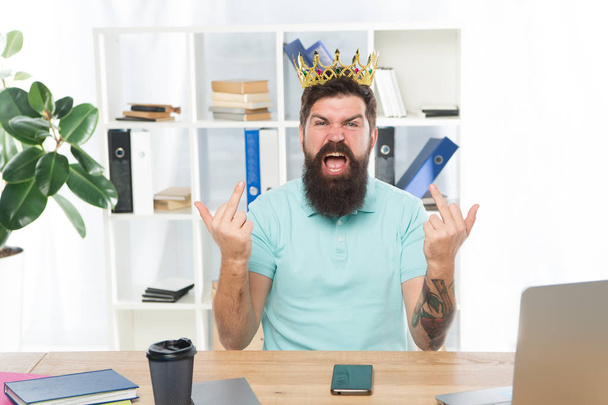 Hate you. Aggressive boss shouting show middle finger gesture. Man arrogant rude boss with golden crown sit in office. Superiority and self confidence. King of office. Serious boss at work place - Fotografie, Obrázek