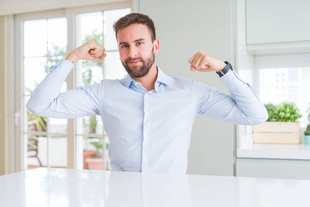 Handsome business man showing arms muscles smiling proud. Fitness concept. - Fotografie, Obrázek