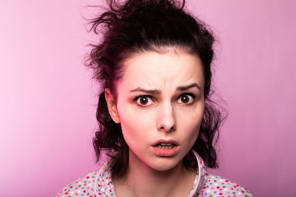 beautiful curly girl in pajamas, pink background - Zdjęcie, obraz
