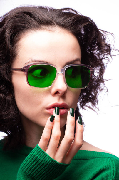beautiful girl in green glasses and green sweater - 写真・画像
