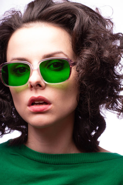 beautiful girl in green glasses and green sweater - Fotó, kép
