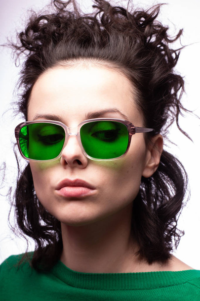 beautiful girl in green glasses and green sweater - Foto, afbeelding