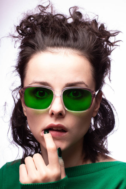 beautiful girl in green glasses and green sweater - Photo, image