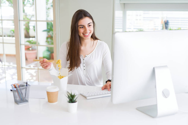 Beautiful young business woman working using computer, smiling a - Fotó, kép