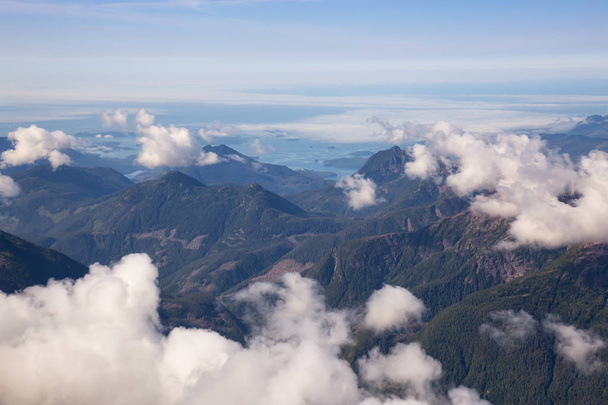 Aerial Landscape View of Beautiful Coastal Mountains on the Pacific Ocean Coast during a sunny summer morning. Taken near Tofino and Ucluelet, Vancouver Island, British Columbia, Canada. - Fotografie, Obrázek