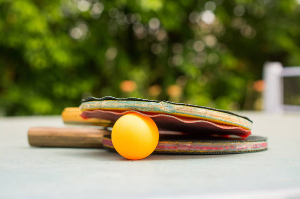 Ping pong kürekler ve Retro mavi ahşap arka planda topu. Rac - Fotoğraf, Görsel