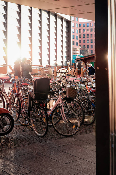 Bicycles parked near Potsdamer Platz Bahnhof station Berlin - Fotó, kép