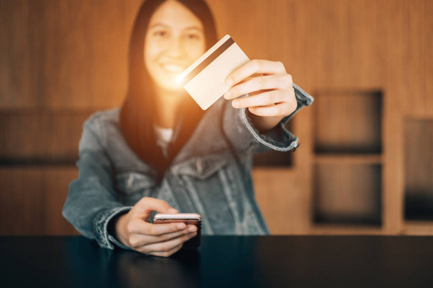beautiful woman holding credit card enjoying in shopping looking - 写真・画像