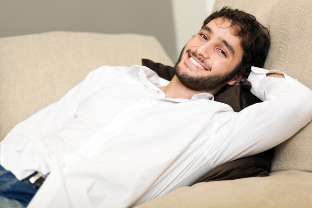 Young man relaxing on the sofa - Foto, imagen