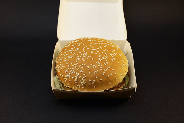 Harmful burger, fast food on a dark background. - Fotó, kép